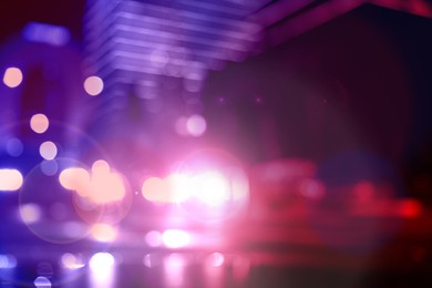 Image of Police red and blue lights in city at night, blurred view