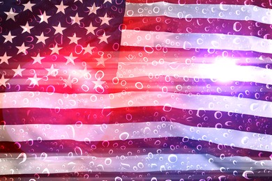 Image of Police red and blue lights, flag of United States of America, view through wet glass