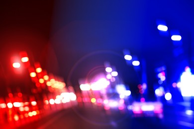 Image of Police red and blue lights in city at night, blurred view