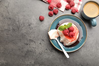 Photo of Delicious panna cotta with berries, sauce and mint on grey textured table, flat lay. Space for text
