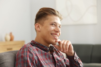 Photo of Dream come true. Positive young man thinking about something at home