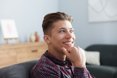 Photo of Dream come true. Positive young man thinking about something at home