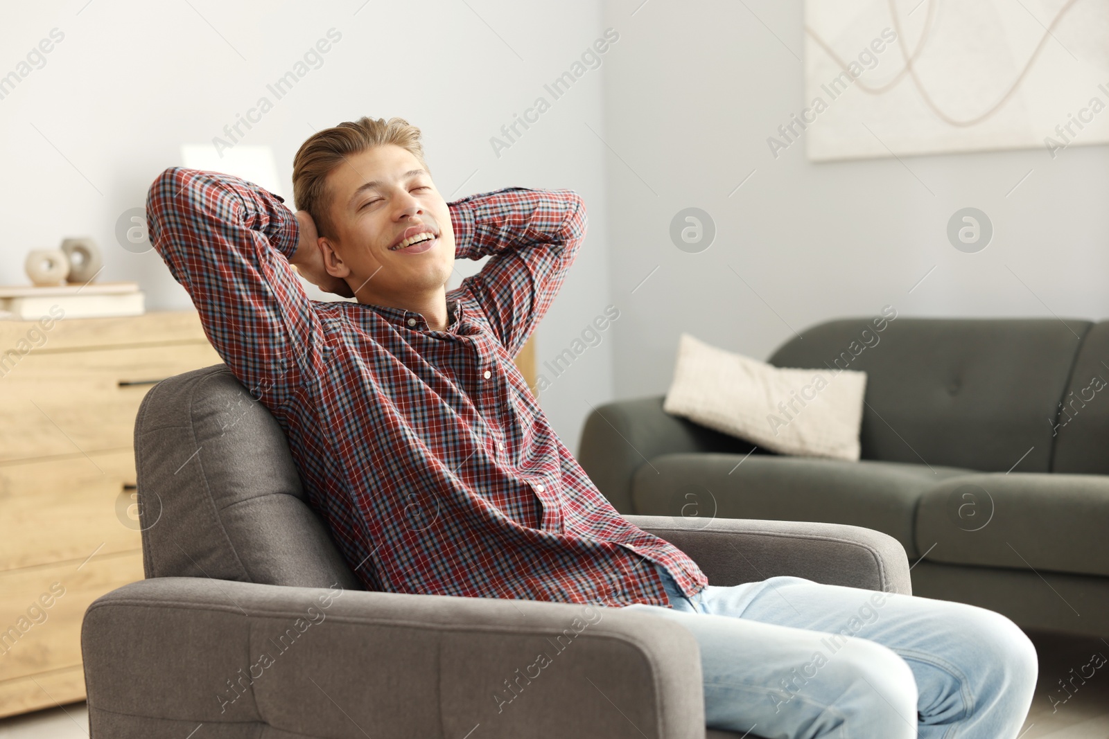 Photo of Dream come true. Positive young man thinking about something at home