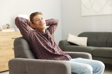 Photo of Dream come true. Positive young man thinking about something at home