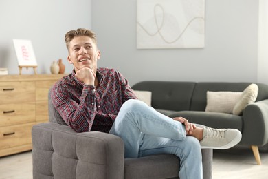 Photo of Dream come true. Positive young man thinking about something at home