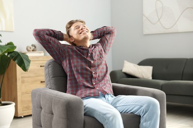 Photo of Dream come true. Positive young man thinking about something at home