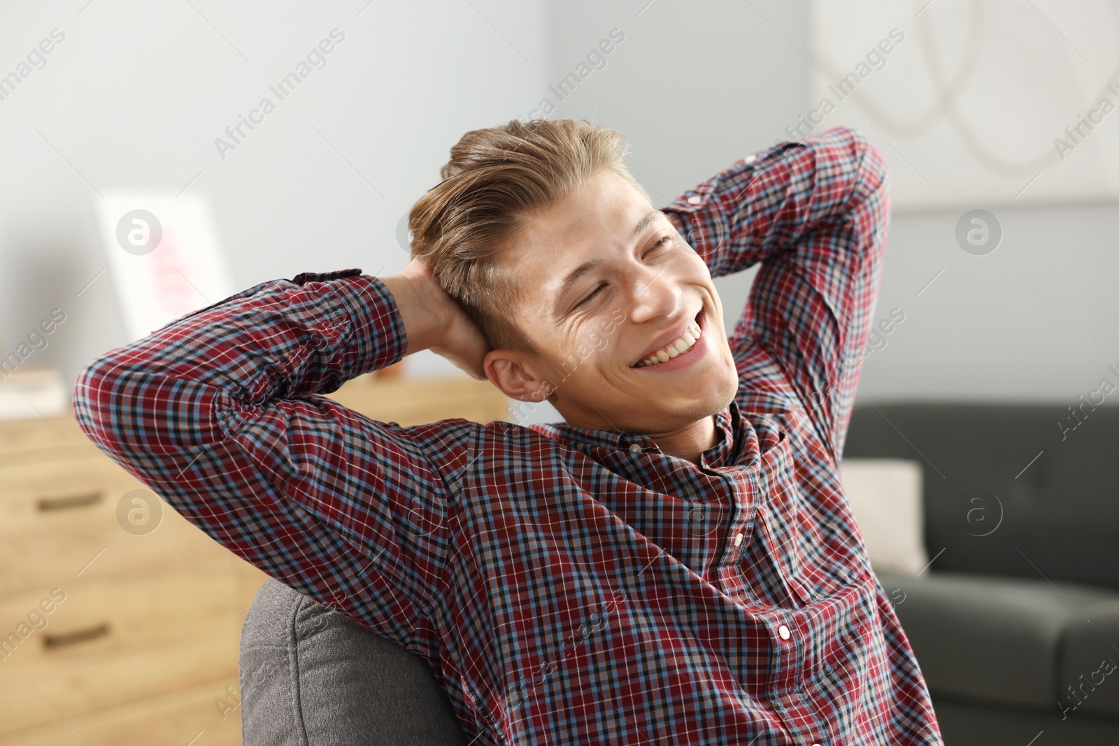 Photo of Dream come true. Positive young man thinking about something at home