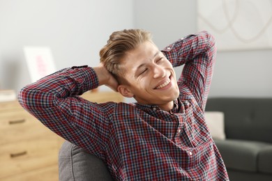 Photo of Dream come true. Positive young man thinking about something at home