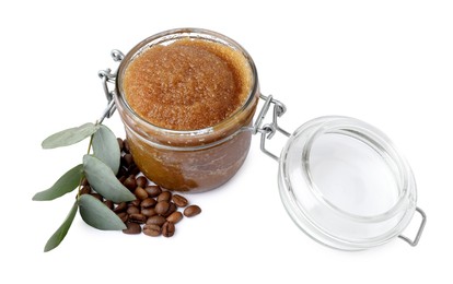 Photo of Natural body scrub in glass jar, coffee beans and eucalyptus branch isolated on white