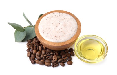 Photo of Natural body scrub in bowl, coffee beans, oil and eucalyptus branch isolated on white