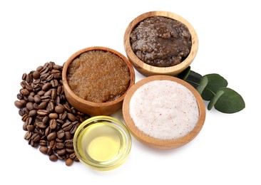 Photo of Natural body scrubs in bowls, coffee beans, oil and eucalyptus branch isolated on white, above view