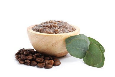 Photo of Natural body scrub in wooden bowl, coffee beans and eucalyptus branch isolated on white