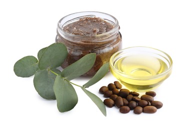 Photo of Natural body scrub in glass jar, coffee beans, oil and eucalyptus branch isolated on white
