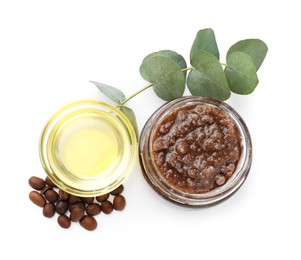 Photo of Natural body scrub in glass jar, coffee beans, oil and eucalyptus branch isolated on white, top view