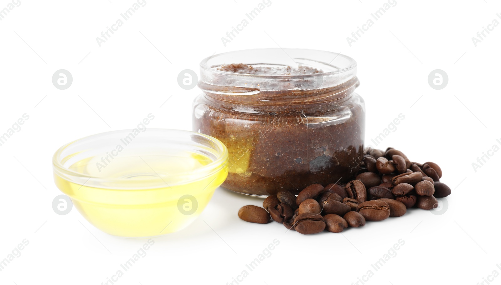 Photo of Natural body scrub in glass jar, coffee beans and oil isolated on white