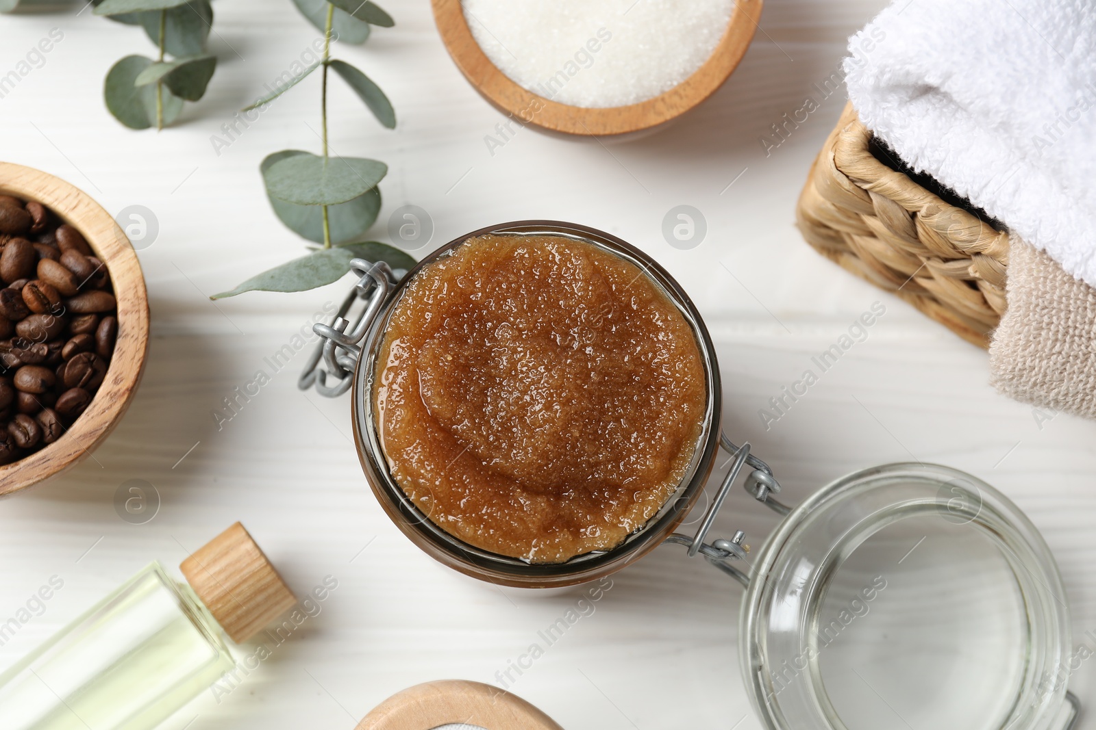 Natural body scrub, ingredients and towels on white wooden table, flat lay Photo of Natural body scrub, ingredients and towels on white wooden table, flat lay