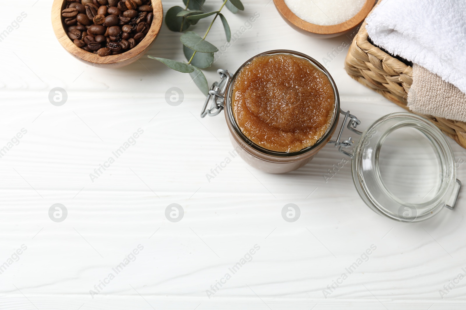 Natural body scrub, ingredients and towels on white wooden table, flat lay. Space for text Photo of Natural body scrub, ingredients and towels on white wooden table, flat lay. Space for text