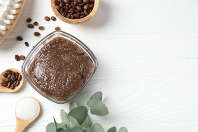 Photo of Natural body scrub in glass bowl, ingredients and brush on white wooden table, flat lay. Space for text