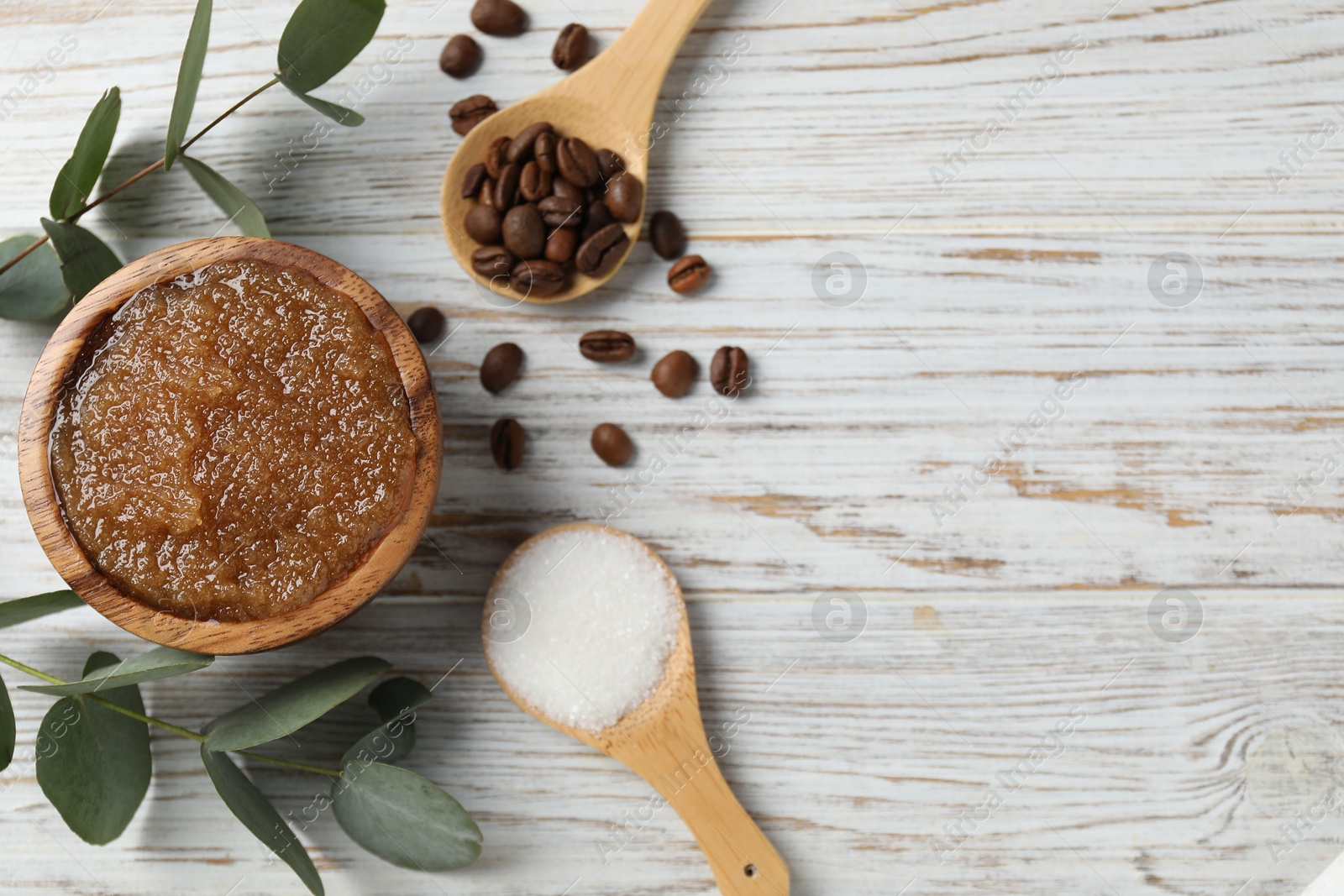 Photo of Natural body scrub in bowl and ingredients on wooden table, flat lay. Space for text