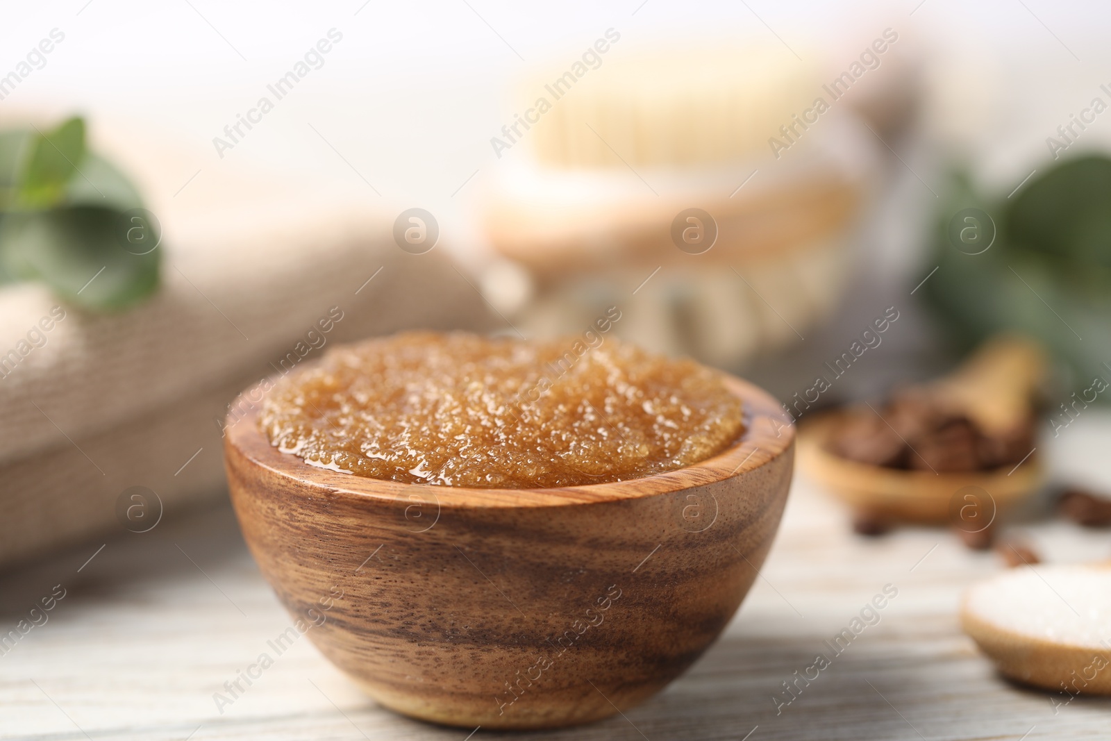 Natural body scrub in bowl on wooden table, closeup Photo of Natural body scrub in bowl on wooden table, closeup