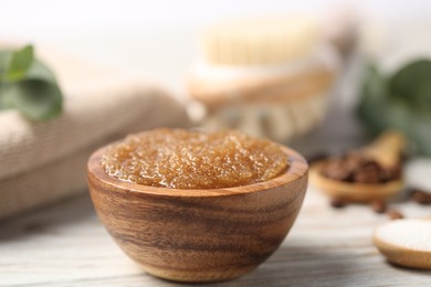 Photo of Natural body scrub in bowl on wooden table, closeup