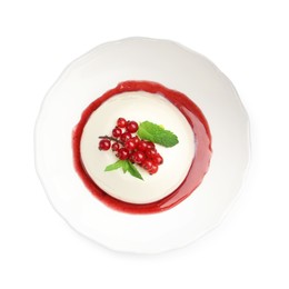 Photo of Delicious panna cotta with red currants, sauce and mint isolated on white, top view