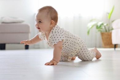 Photo of Cute little baby crawling on floor at home