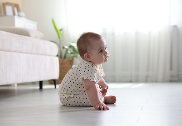 Photo of Cute little baby crawling on floor at home