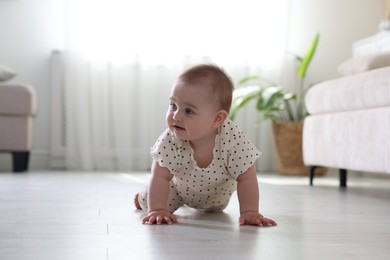 Photo of Cute little baby crawling on floor at home