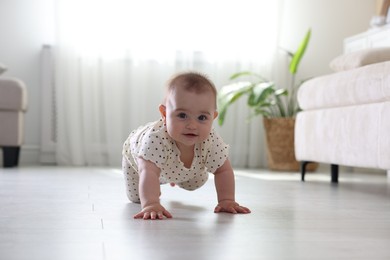 Photo of Cute little baby crawling on floor at home