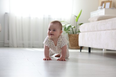 Photo of Cute little baby crawling on floor at home