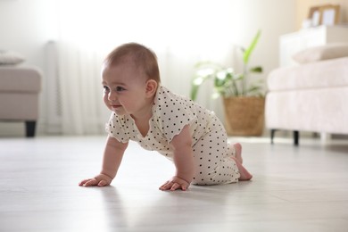 Photo of Cute little baby crawling on floor at home