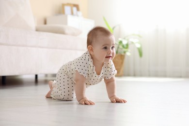 Photo of Cute little baby crawling on floor at home