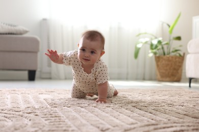 Photo of Cute little baby crawling on floor at home