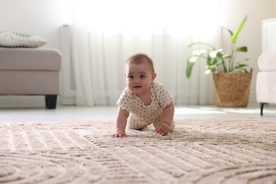 Photo of Cute little baby crawling on floor at home