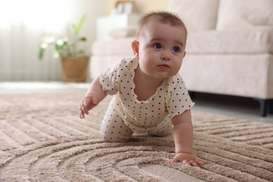 Photo of Cute little baby crawling on floor at home