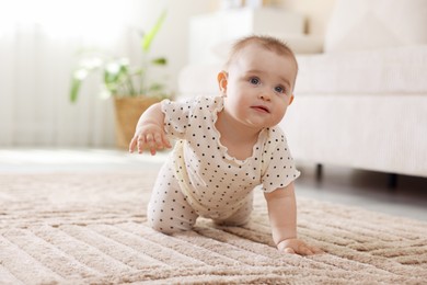 Photo of Cute little baby crawling on floor at home