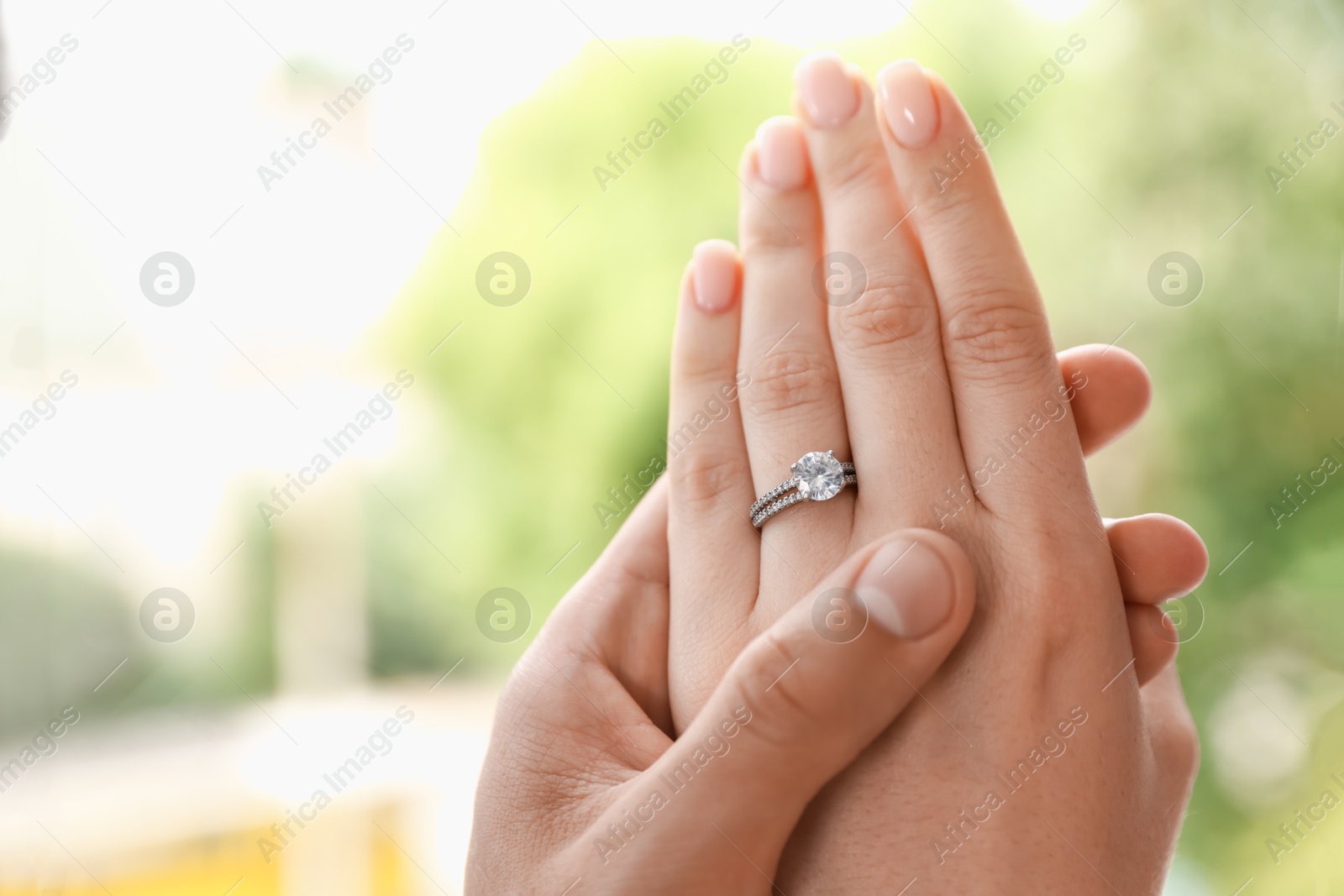 Making proposal. Woman with engagement ring and her fiance holding hands outdoors, closeup. Space for text Photo of Making proposal. Woman with engagement ring and her fiance holding hands outdoors, closeup. Space for text