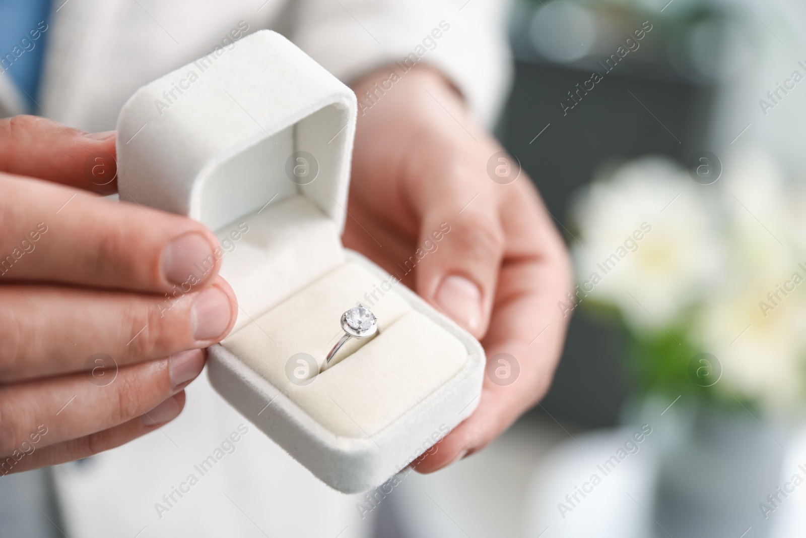 Making proposal. Man with engagement ring indoors, closeup Photo of Making proposal. Man with engagement ring indoors, closeup