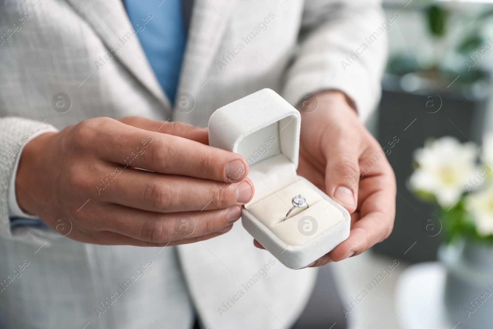 Making proposal. Man with engagement ring indoors, closeup Photo of Making proposal. Man with engagement ring indoors, closeup