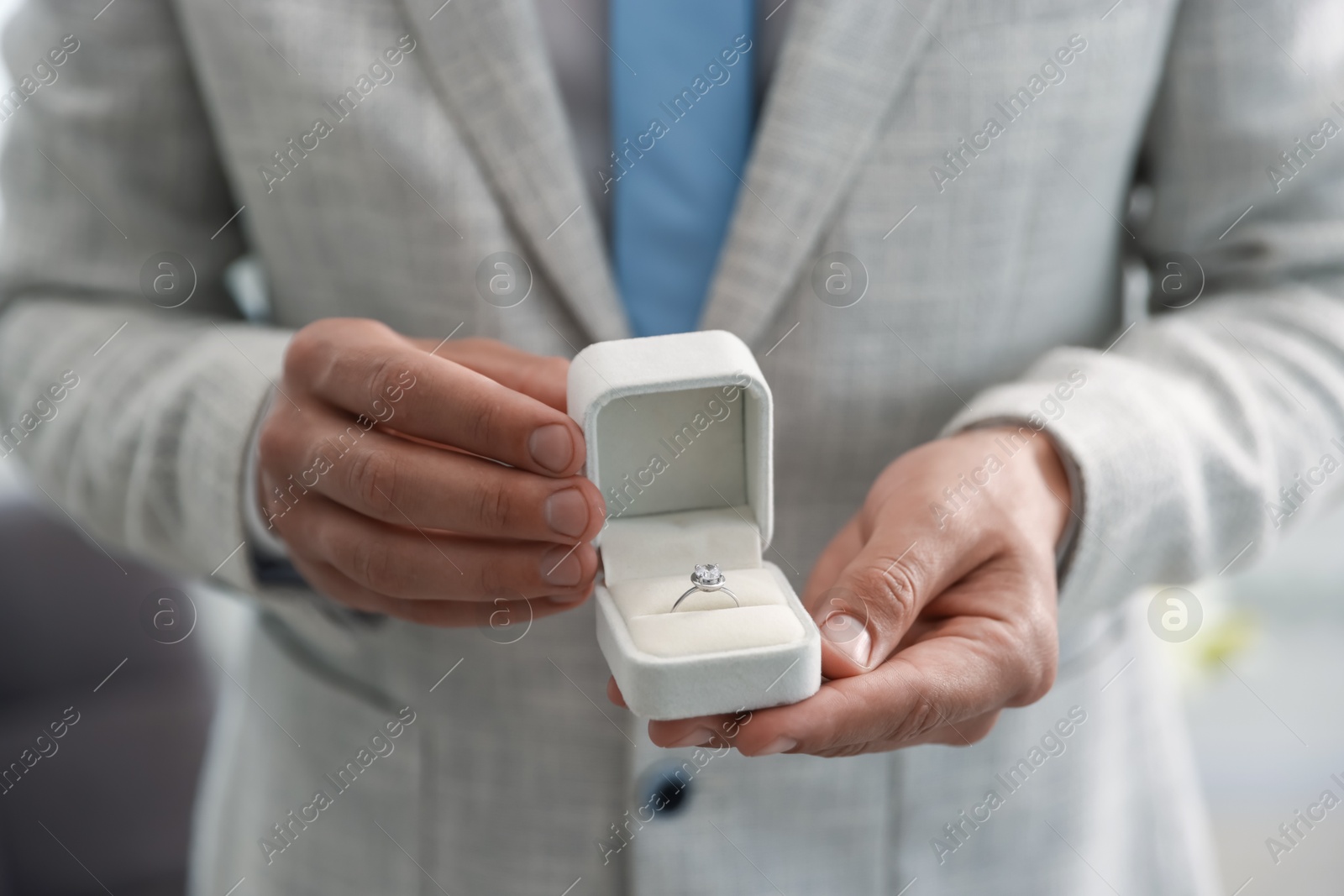 Making proposal. Man with engagement ring indoors, closeup Photo of Making proposal. Man with engagement ring indoors, closeup