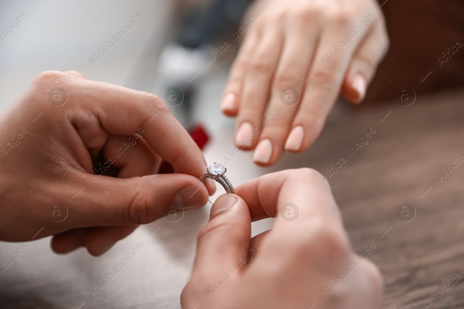 Man with engagement ring making marriage proposal to his girlfriend indoors, closeup Photo of Man with engagement ring making marriage proposal to his girlfriend indoors, closeup