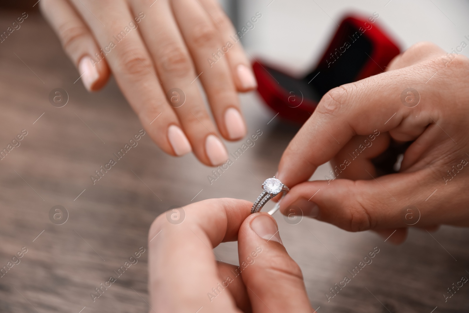 Man with engagement ring making marriage proposal to his girlfriend indoors, closeup Photo of Man with engagement ring making marriage proposal to his girlfriend indoors, closeup