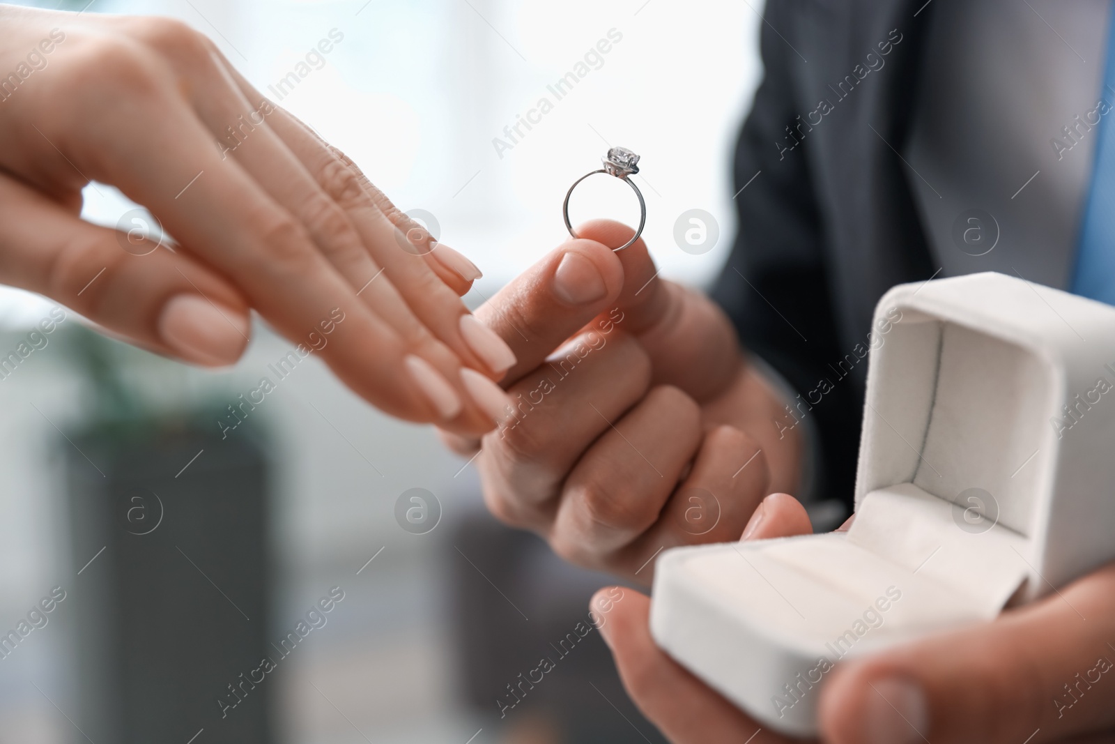 Man with engagement ring making marriage proposal to his girlfriend indoors, closeup Photo of Man with engagement ring making marriage proposal to his girlfriend indoors, closeup