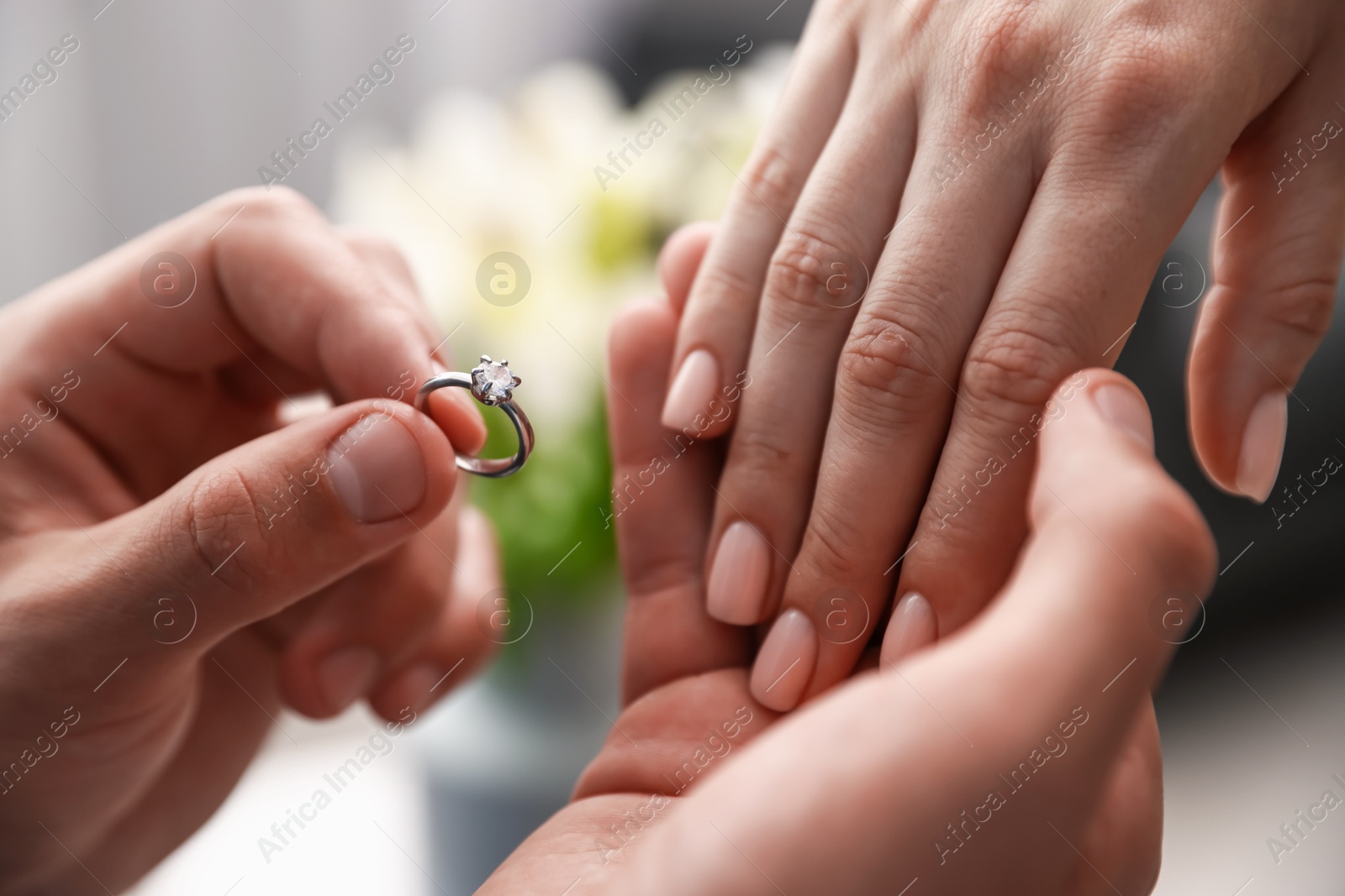 Man with engagement ring making marriage proposal to his girlfriend indoors, closeup Photo of Man with engagement ring making marriage proposal to his girlfriend indoors, closeup