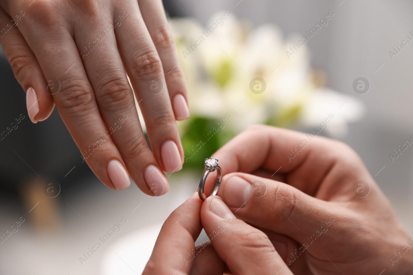 Man with engagement ring making marriage proposal to his girlfriend indoors, closeup Photo of Man with engagement ring making marriage proposal to his girlfriend indoors, closeup
