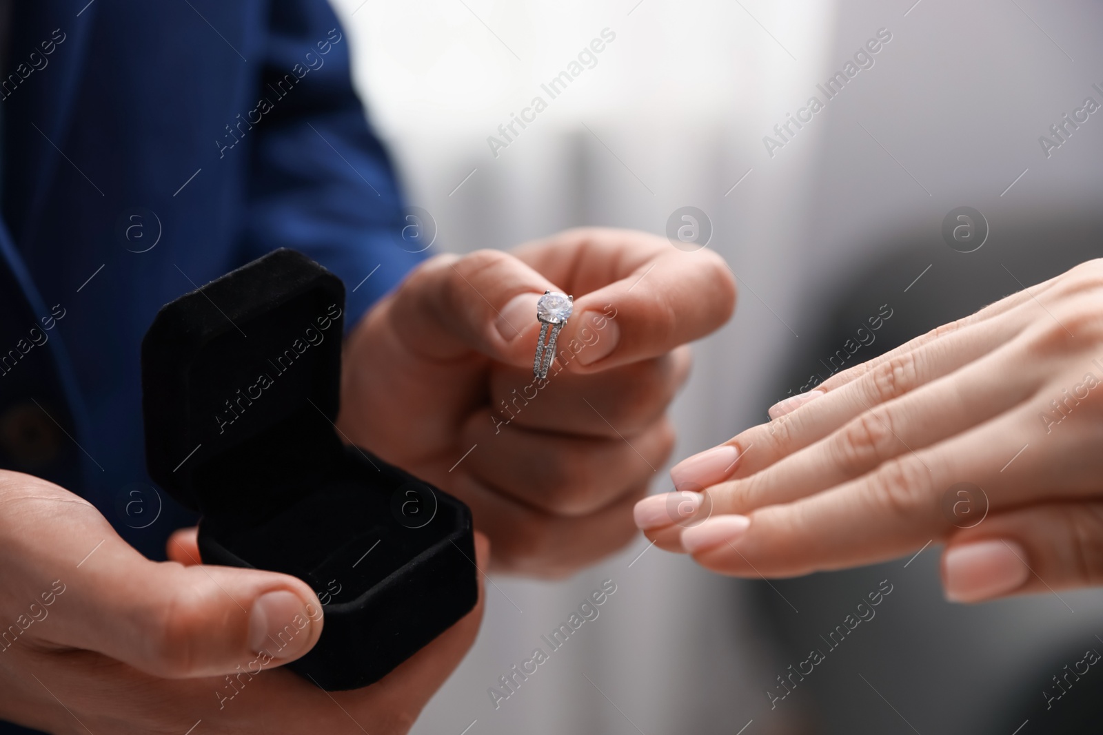 Man with engagement ring making marriage proposal to his girlfriend indoors, closeup Photo of Man with engagement ring making marriage proposal to his girlfriend indoors, closeup