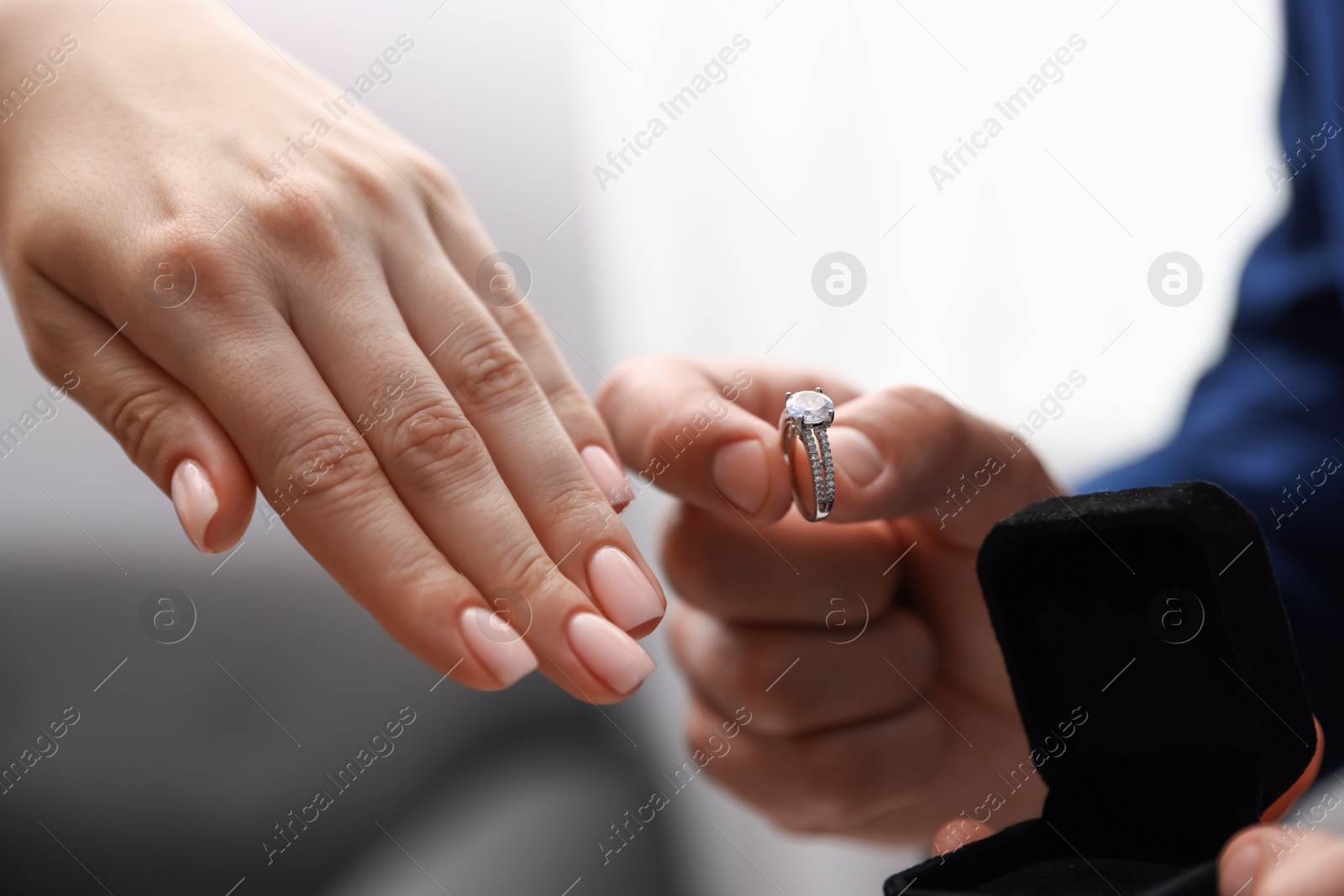 Man with engagement ring making marriage proposal to his girlfriend indoors, closeup Photo of Man with engagement ring making marriage proposal to his girlfriend indoors, closeup