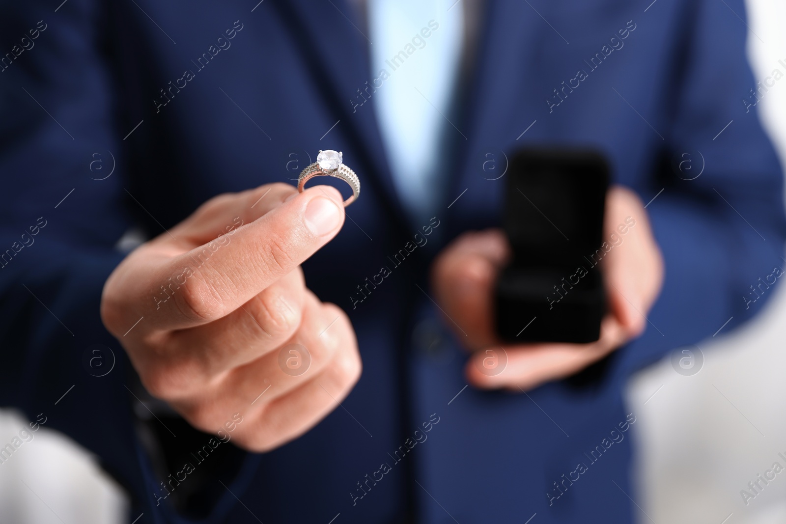 Making proposal. Man with engagement ring indoors, closeup Photo of Making proposal. Man with engagement ring indoors, closeup