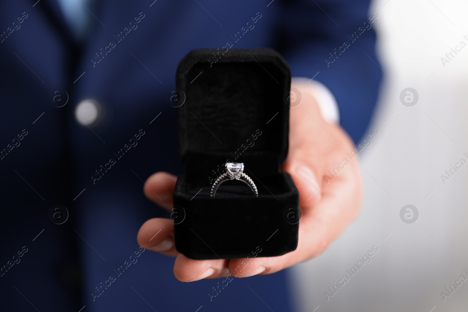 Making proposal. Man with engagement ring indoors, closeup Photo of Making proposal. Man with engagement ring indoors, closeup
